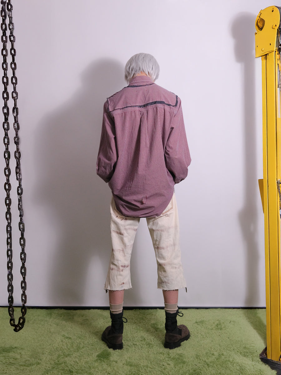 Back view of vintage reworked pants detailed with distressed finish and raw edge hem