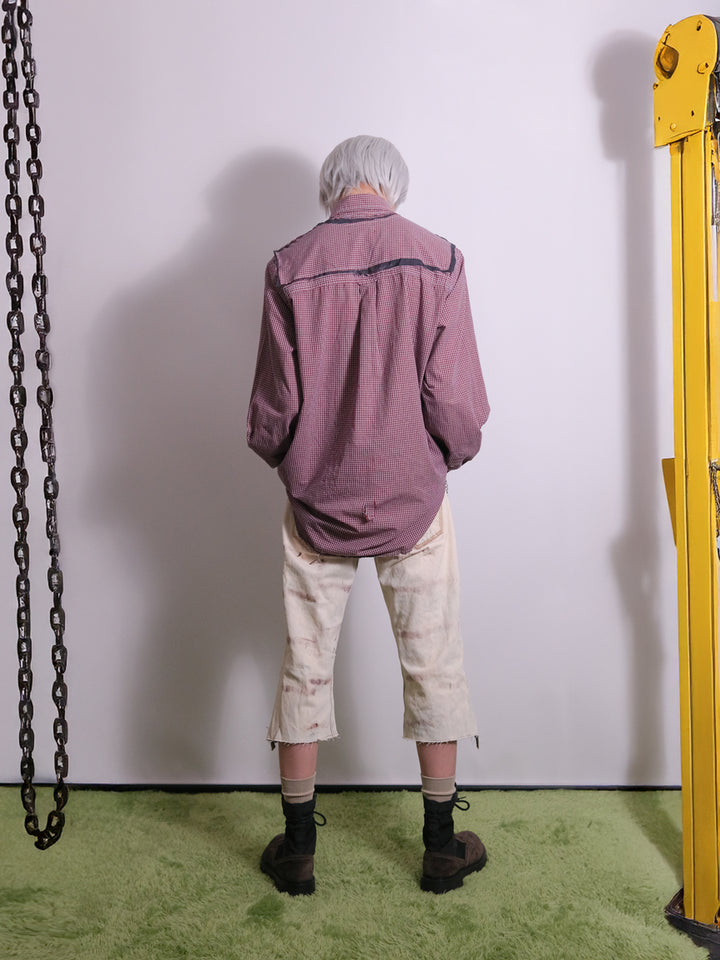 Back view of vintage reworked pants detailed with distressed finish and raw edge hem