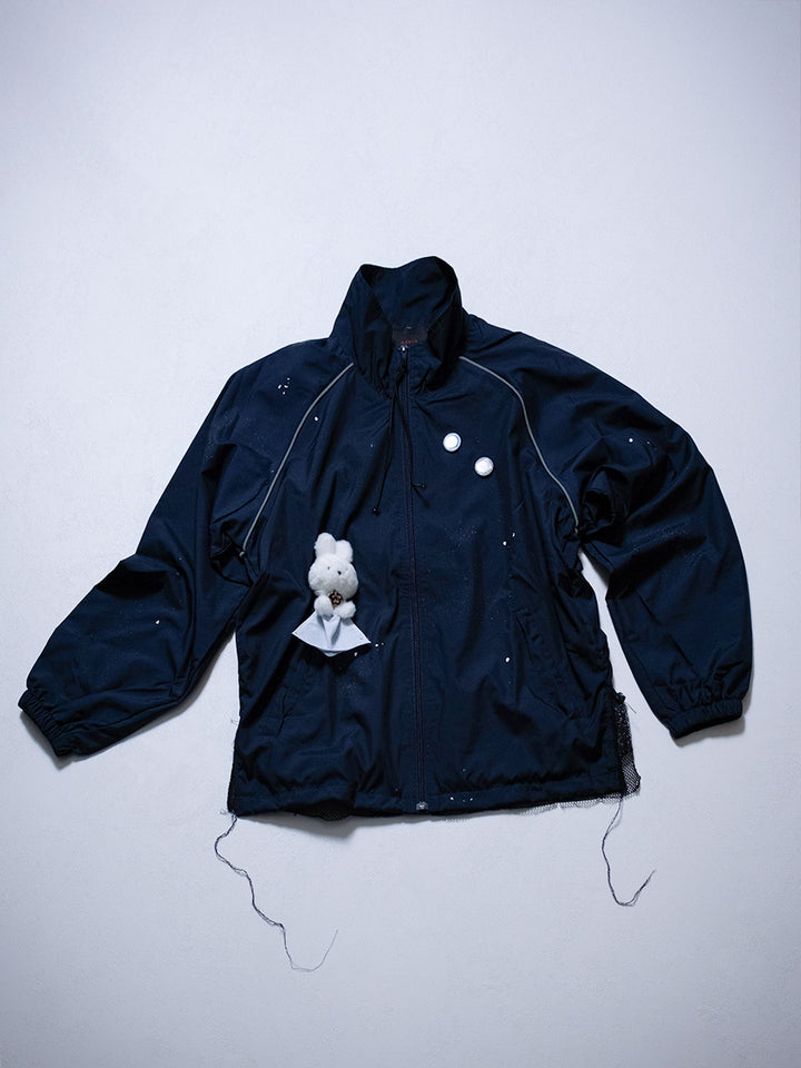 Front view of one-of-one upcycled rabbit jacket featuring detachable badges and raglan sleeves