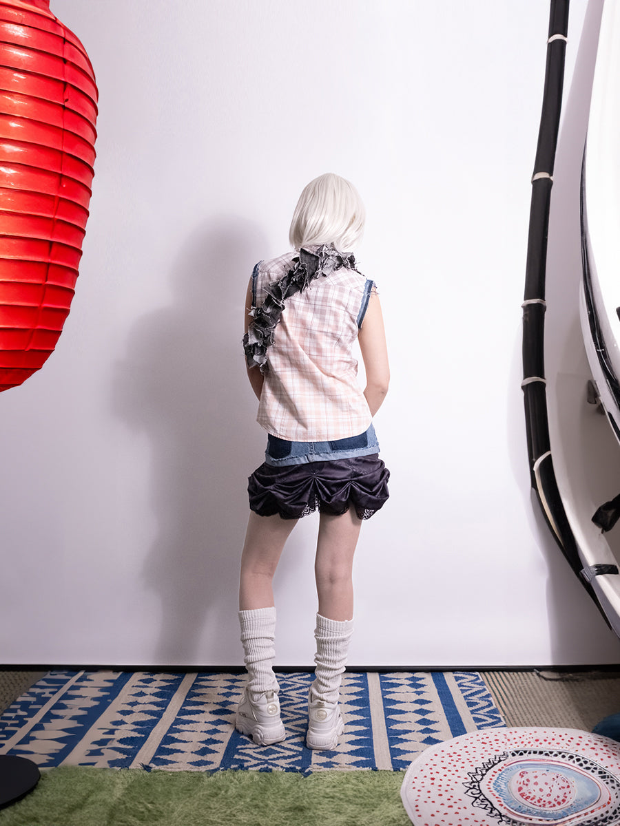 Back view of vintage reworked skirt detailed with layered construction and bar piercing accents