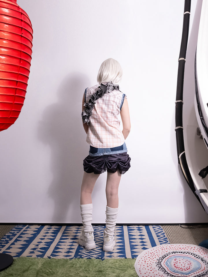 Back view of vintage reworked skirt detailed with layered construction and bar piercing accents