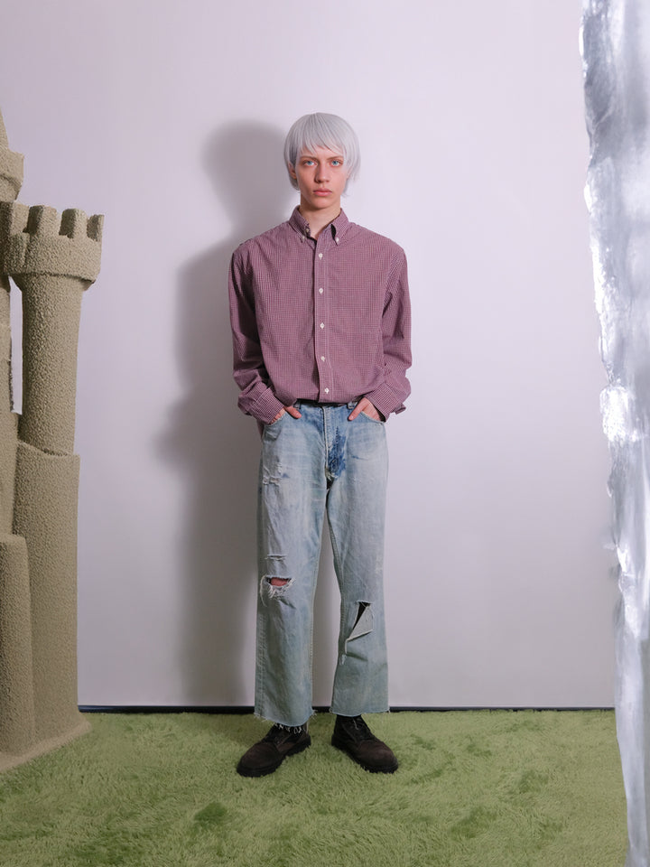 Front view of one-of-one upcycled jeans featuring distressed finish, 4-pocket styling, and belt loops