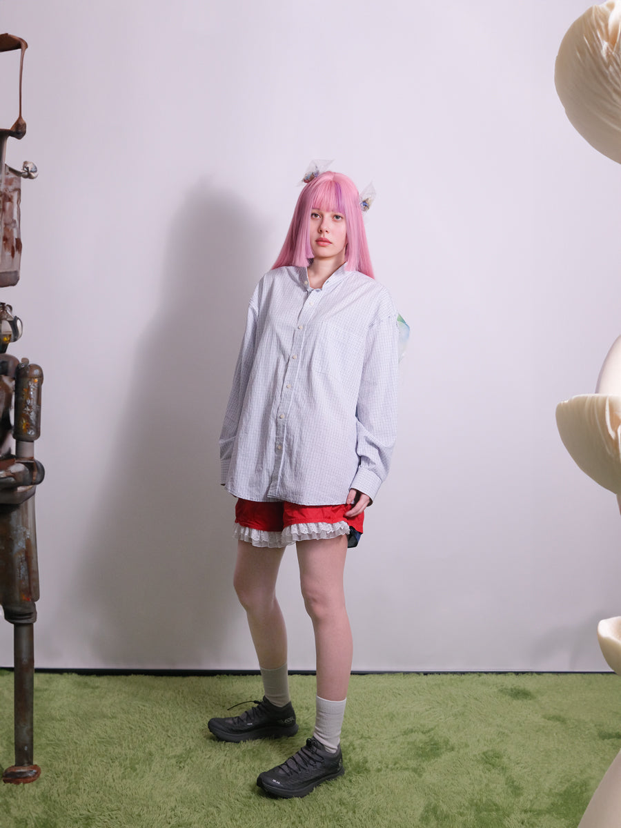 Side view of upcycled shirt with deconstructed sleeves and asymmetric hemline
