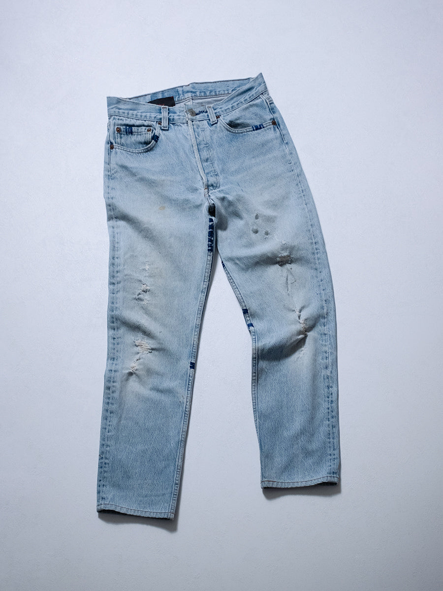 One-of-one upcycled jeans, front product shot with hand stitching, distressing, and button-fly