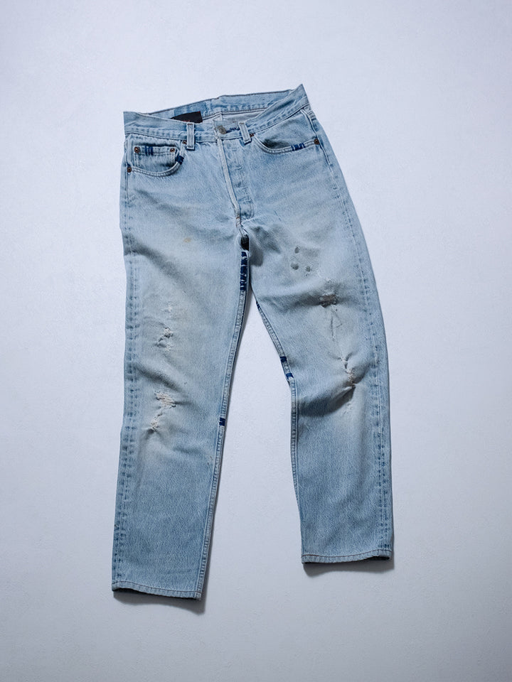 One-of-one upcycled jeans, front product shot with hand stitching, distressing, and button-fly
